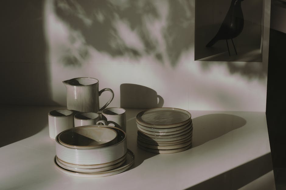 Interior view of a modern café in Paddington, featuring polished light grey tile flooring and wooden dining tables with matching chairs. The space includes decorative elements such as a large mirror